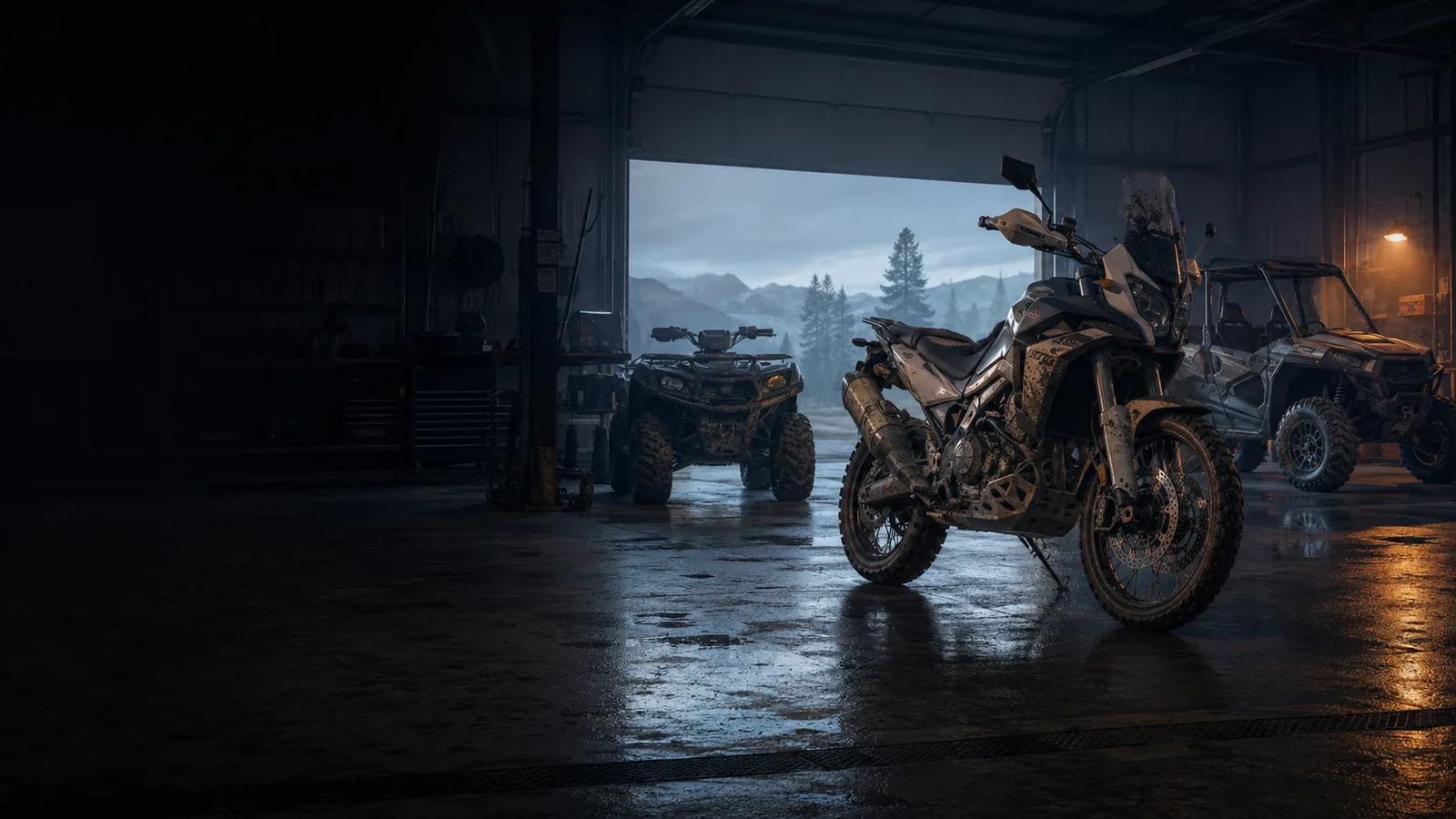 A motorcycle, ATV, and side-by-side in a workshop